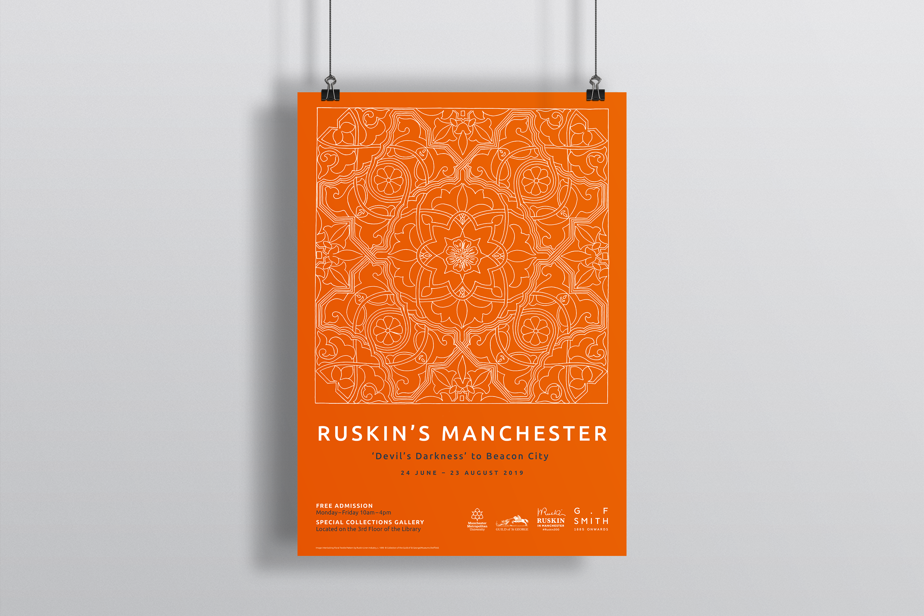 Orange poster with white pattern advertising ruskin's manchester exhibition, help up with string and bulldog clips