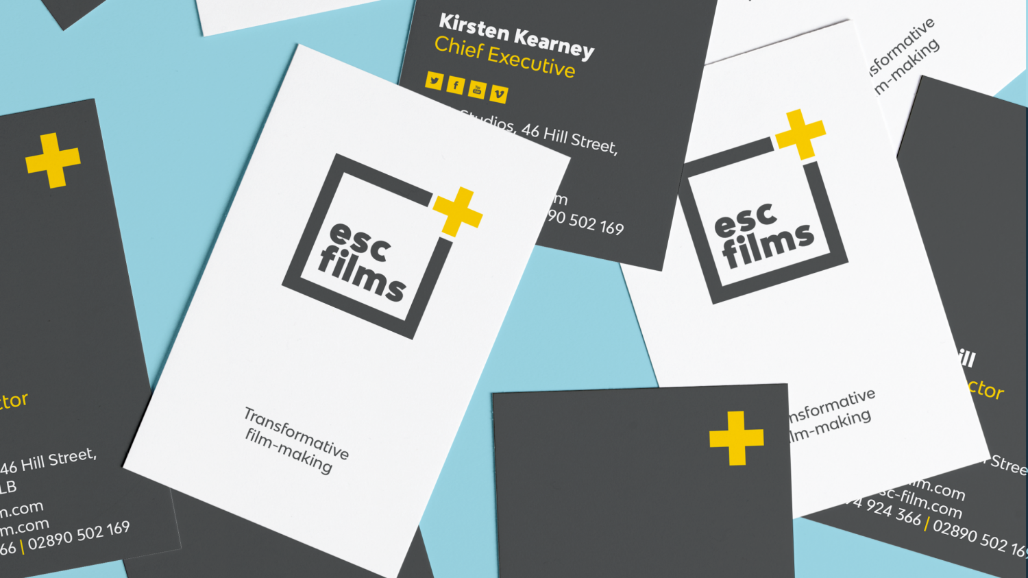 lots of grey and white business cards scattered on blue background with esc films logo and details