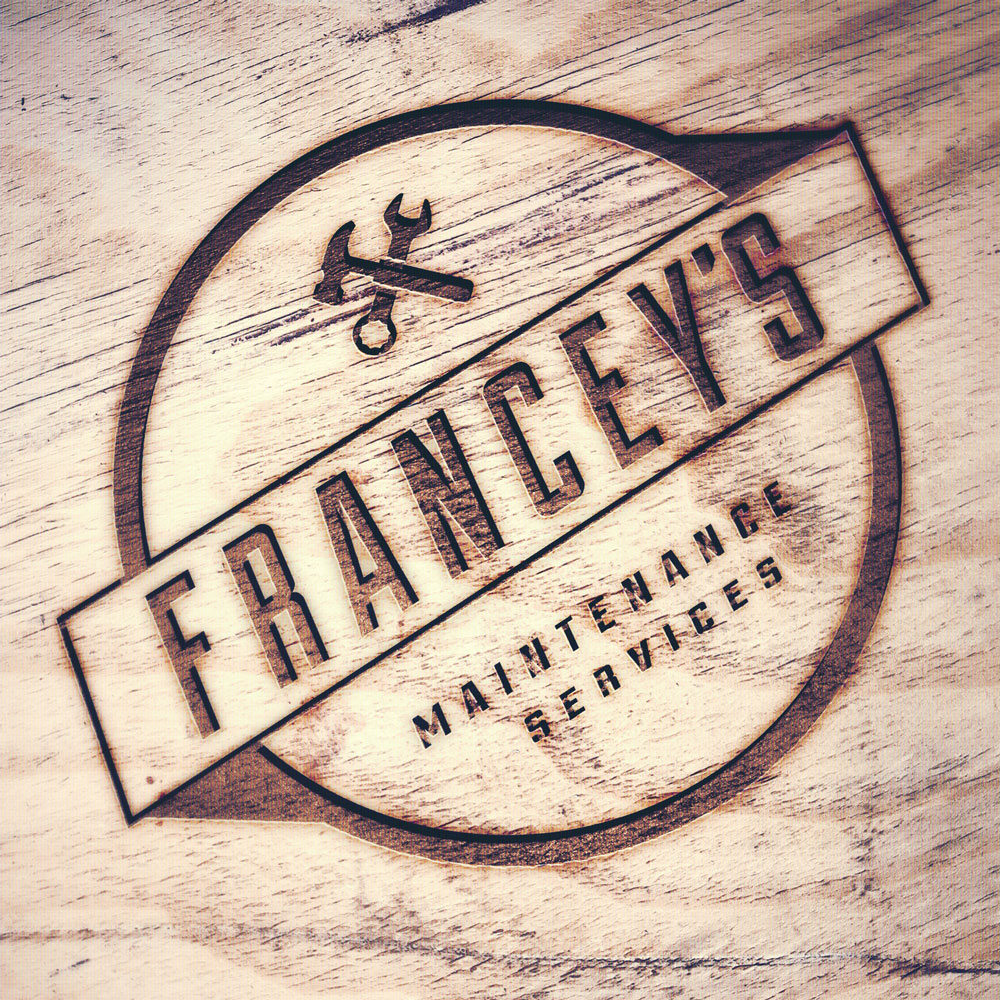 Wood burn of Francey's Maintenance services logo with hammer and spanner